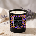 Black Amber & Lavender candle close-up showing its label, cream wax, and two wicks.