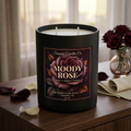 Moody Rose candle in a warm bedroom with burgundy roses
