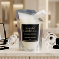 Designer Inspired squeezable wax melt pouch with black ivory and gold label on a luxury marble vanity