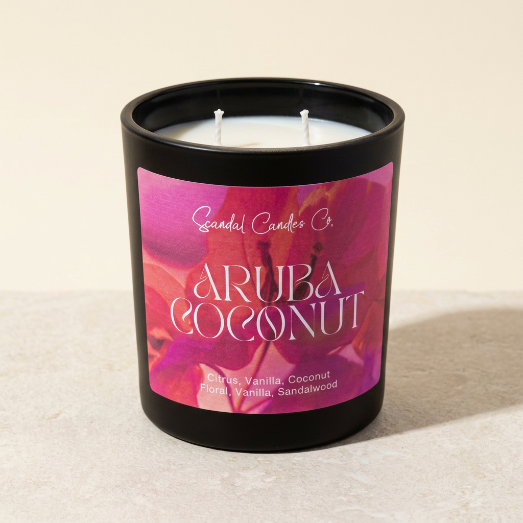 Aruba Coconut candle with a pink label and two white wicks on an ivory studio background