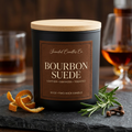 Bourbon Suede matte black candle with a wooden lid, styled with candied orange peel, rosemary and cloves.