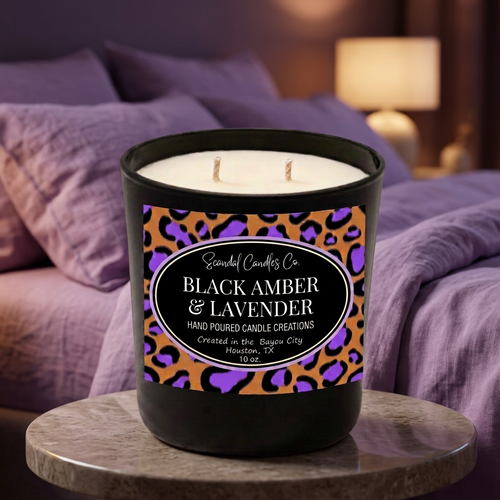 Black Amber & Lavender 10 oz candle with purple leopard oval label in a cozy lavender bedroom setting