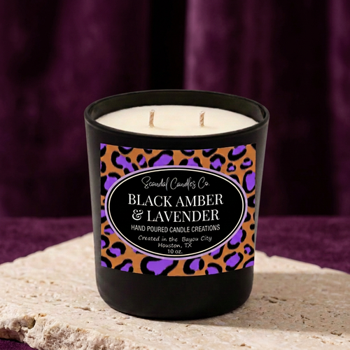 Black Amber & Lavender 10 oz candle with purple leopard oval label against a plum studio backdrop
