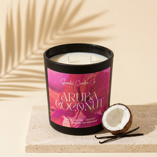 Aruba Coconut candle styled with coconut and vanilla pods on pale stone