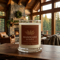 Mahogany Reserve 9 oz candle in a forest reserve lodge with timber beams and stone fireplace