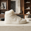 Large white sneaker candle displayed in a collector-inspired lounge