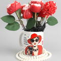 Scandal Candles Co. rose bouquet candle set featuring red wax roses in a fashion-illustrated mug with pearl accents.